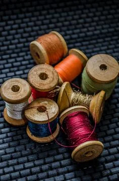 Retro sewing items: tailoring scissors, cutting knife, thimble, wooden thread Stock Photos