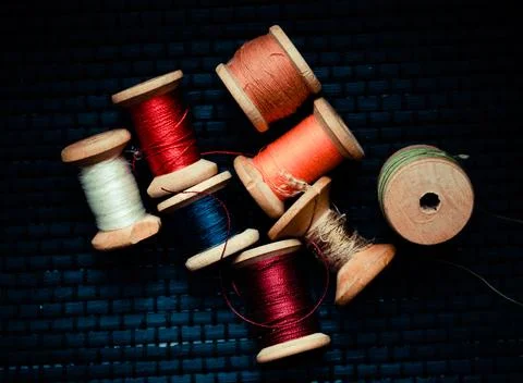 Retro sewing items: tailoring scissors, cutting knife, thimble, wooden thread Stock Photos