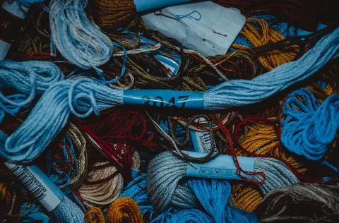 Retro sewing items: tailoring scissors, cutting knife, thimble, wooden thread Stock Photos