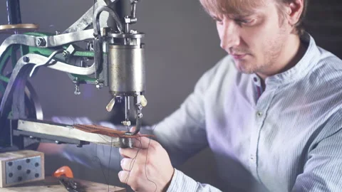 Retro Sewing Machine Needle. Leather craftsman creates a craft product. 動画素材 130215644