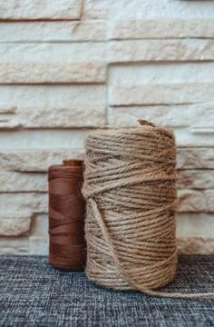 Retro sewing tools: old scissors, bobbins of thread on gray fabric. Tailor's  Stock Photos