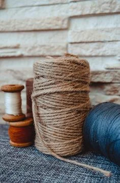 Retro sewing tools: old scissors, bobbins of thread on gray fabric. Tailor's  Stock Photos