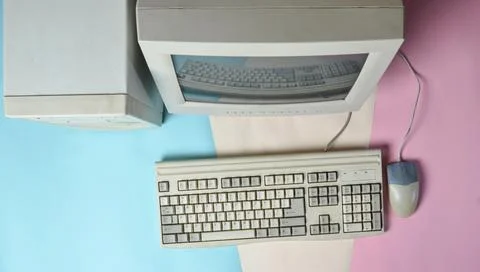 Retro stationary computer on colored background. Monitor, system unit, comput Stock Photos