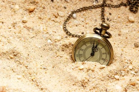 Retro style clock in the sand Stock Photos