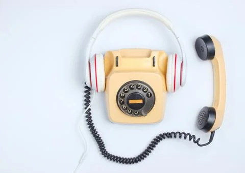 Retro style creative flat lay. Rotary vintage telephone with classic white ea Stock Photos