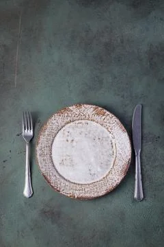Retro style dinner table setting on green and grey vintage background, mock up Stock Photos