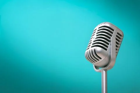 Retro style microphone on green wall background with light comes to the left Stock Photos