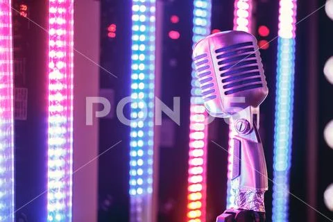 Retro style microphone on stage in the spotlight performance of the musical grou Stock Photos