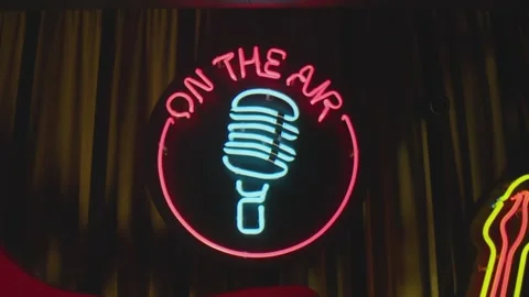 Retro style neon microphone sign hanging on the wall in club or pub . Stock Footage 167358267