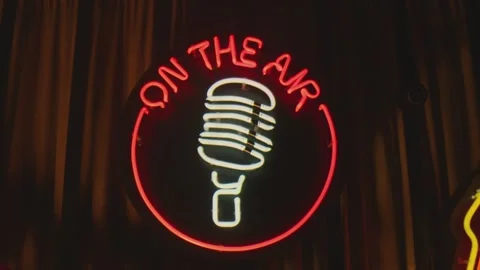 Retro style neon microphone sign hanging on the wall in club or pub . Stock Footage 167359695