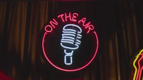 Retro style neon microphone sign hanging on the wall in club or pub . Stock Footage 167360062