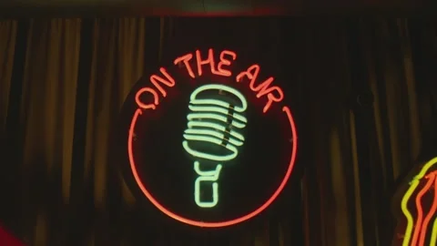 Retro style neon microphone sign hanging on the wall in club or pub . Stock Footage 167360954