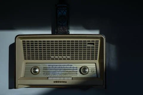Retro style radio receiver with knobs for searching stations. Front of vintag 写真素材