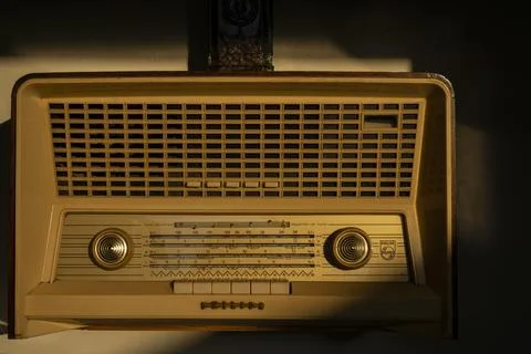 Retro style radio receiver with knobs for searching stations. Front of vintag 写真素材