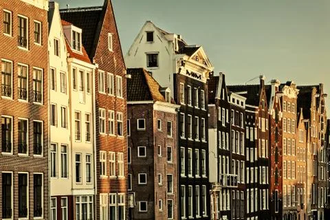 Retro styled image of ancient canal houses in Amsterdam Stock Photos