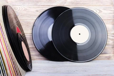 Retro styled image of a collection of old vinyl record lp's with sleeves on.. Stock Photos