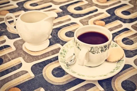 Retro styled image of a cup of coffee and milk can Stock Photos