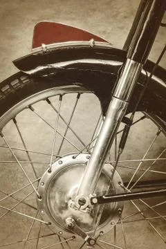 Retro styled image of the front of an old motorcycle Photos