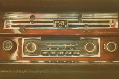 Retro styled image of an old dashboard with seventies car radio Stock Photos