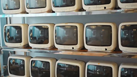 A retro styled room with a wall of cathode ray tube televisions. 스톡 동영상 330191993