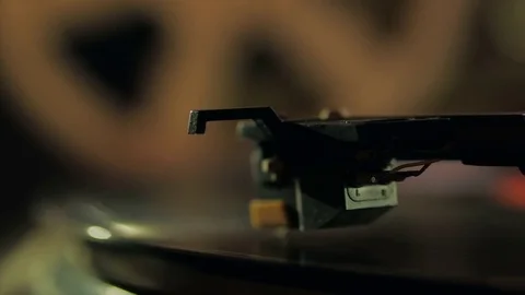 A retro-styled spinning record vinyl player against the background of a Stock Footage 74866584