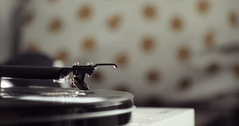 Retro-styled spinning record vinyl player on blur background, closeup side view. Stock Footage 108013673