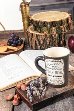 Retro table with book and cup of tea or coffee Stock Photos