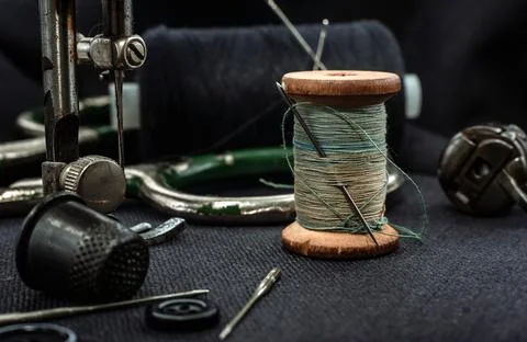 Retro tools for cutting and sewing. Needle with thread, thimble, sewing Stock Photos