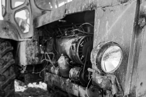 Retro tractor closeup, front view, dirty and shabby, monochrome effect Fotos Stock