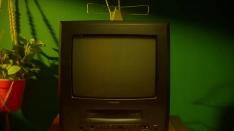Retro TV with built-in VHS player placed on wooden cabinet Vídeo Stock 296578596