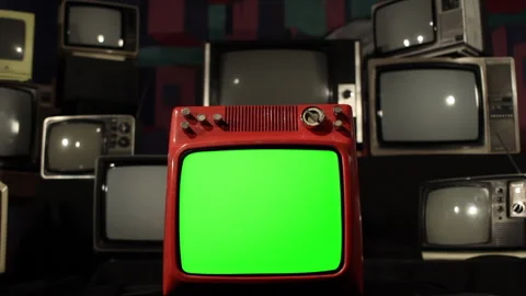 Retro TV with Green Screen Exploding Amid Stacked Old Televisions - 4K Video stock 297394589