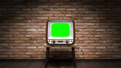 Retro TV receiver with green screen standing on a table, brick wall Stock Footage 220722795
