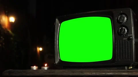 Retro TV Set with Green Screen and Lit Candles Outdoors at Night. Closeup. Stock Footage 124354874