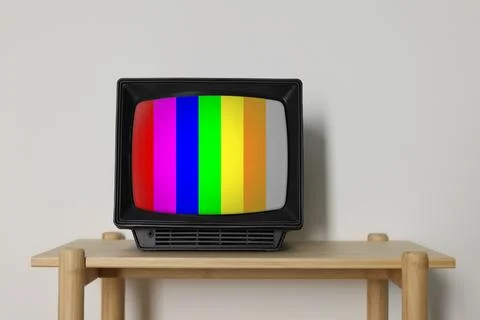 Retro TV set with test pattern on wooden table near white wall. Color bars .. 写真素材