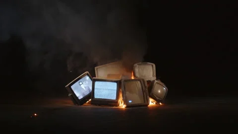 Retro TVs burning in fire. Concept of anti-propaganda. Burning television Stock Footage 138762718