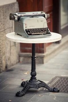 Retro typewriter on a forged openwork table. Stock Photos