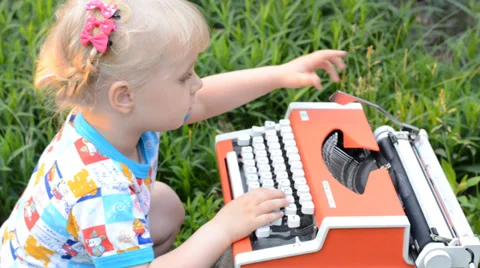 Retro Typewriter Machine in use. Little Girl Writer Printing in a Garden. Stock Footage 39417532