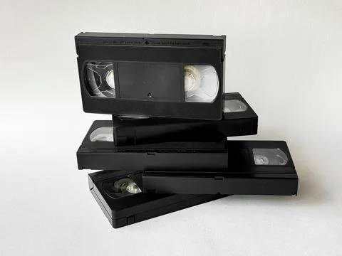 Retro vhs tapes stack on white background: nostalgia and vintage media trend Stock Photos