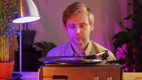 Retro Vinyl record player playing music, man listening the music, close-up macro Stock Footage 251821589