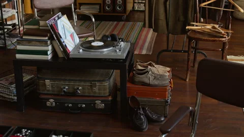 Retro Vinyl Record Player, Suitcases and Footwear at Second Hand Store Stock Footage 327810139