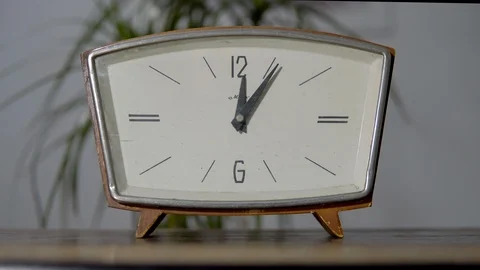 Retro watch with white dial on the table on top of a flower. Video stock 99404246