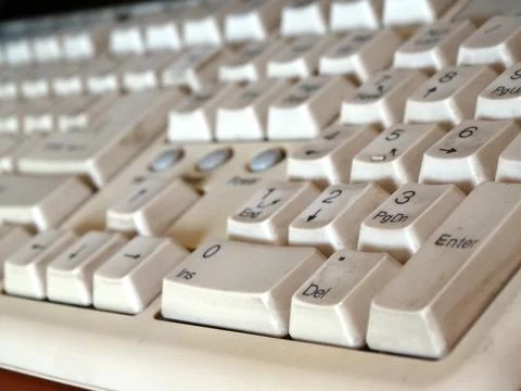 Retro white computer keyboard. Selective focus. Stock Photos
