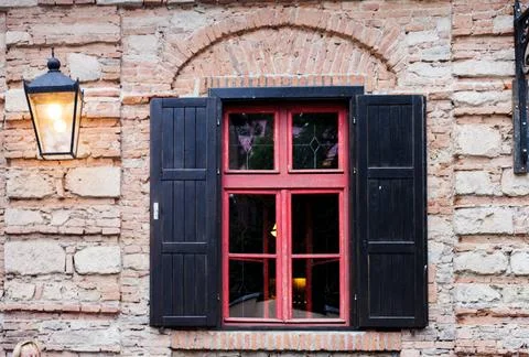 Retro window Retro window with black jalousie outdoor and old brich wall C... Stock-Fotos