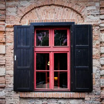 Retro window Retro window with black jalousie outdoor and old brich wall C... Stock-Fotos