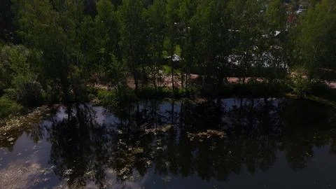 A return flight, gaining altitude above a beautiful lake surrounded by fore.. 스톡 사진