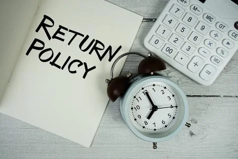 Return Policy text on paper notebook page with alarm clock and calculator o.. Stock Photos