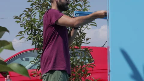 Return to sender. Caucasian man puts a package into a hub locker for the courier Stock Footage 136474847