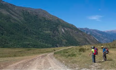 Return of tourists from a hike in the mountains. Stock Photos