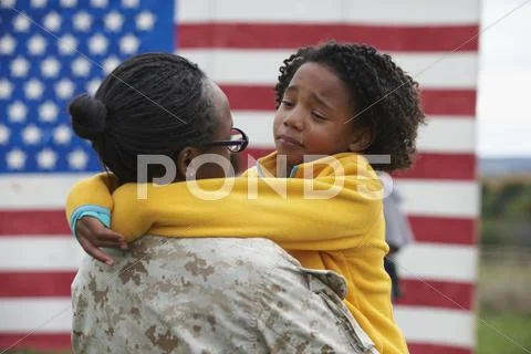Returning Black Soldier Hugging Daughter
