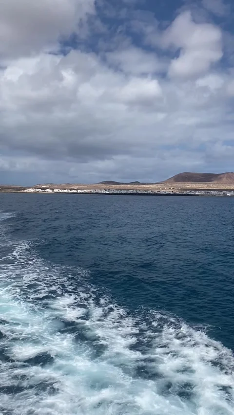 Returning to Lanzarote with views of La Graciosa and Las Agujas over the sea Stock Footage 310637979